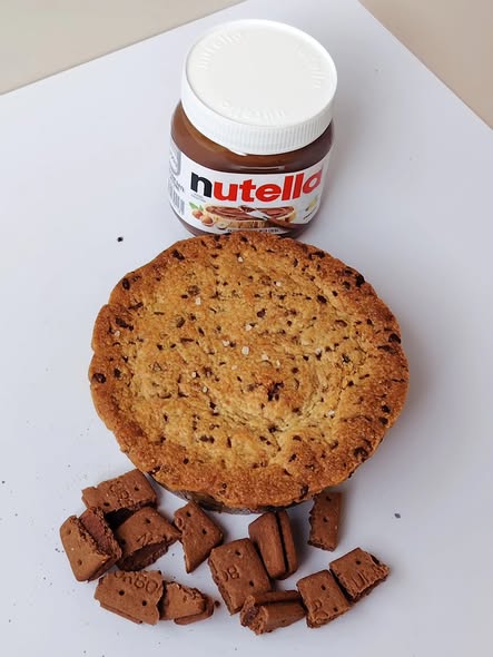 Singapore halal Cookie pie  with Nutella jar and chocolate pieces on a white surface