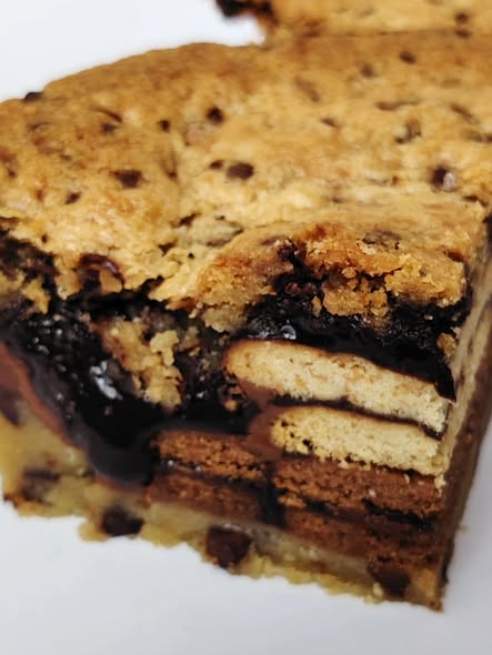 Singapore halal Close-up of a layered cookie pie slice bar with chocolate filling on a white background