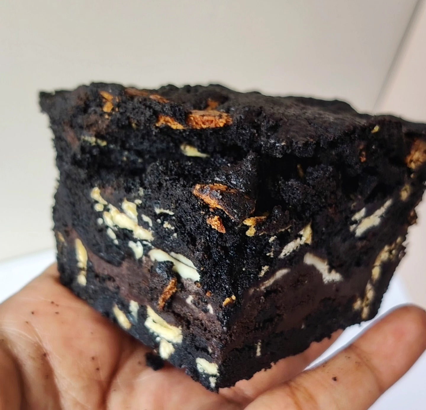 Singapore halal Black oreo blackout layered cookie pie  with brownie on a white surface with a plain background