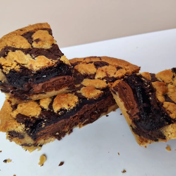 Singapore halal Chocolate chip cookie bars on a white plate with a beige background