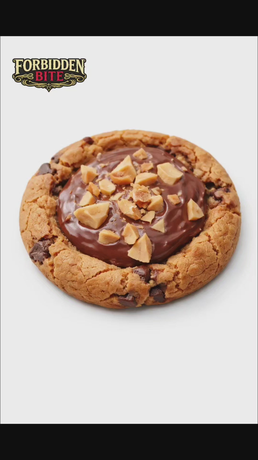 The Nutella Crown Cookie was born when we decided Nutella deserved centre stage — not hidden, not swirled, but sitting boldly in the middle like the main character it is. We baked a rich, buttery chocolate chunk cookie, pressed a crown-shaped well into it, filled it generously with smooth Nutella, then topped it with roasted hazelnut chunks because royalty needs jewels.